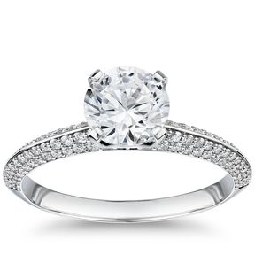 An engagement ring with a single 1-carat diamond and a knife-edge band with rows of micro pavé diamonds.